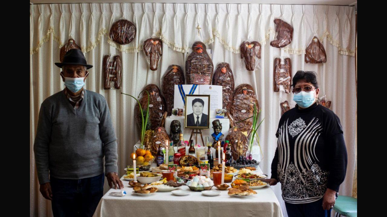 With the pandemic continuing globally, the occasion also involved commemorations of victims of Covid-19. In this photo, family members pose next to an altar of Renan Monroy, 40, who died due to the virus, on the Day of the Dead's eve, in Puno, southern Peru on November 01, 2021. Every first day of the month of November the ancestral custom of the so-called 